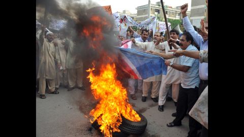 Pakistani Muslims burn a U.S. flag during a protest rally in Islamabad on Saturday. The Pakistani Taliban on Saturday issued a call to young Muslims worldwide and within the country to rise up against an anti-Islam movie. 