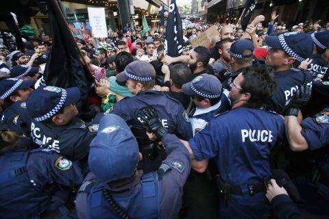 Protesters clash with police on a street in Sydney's central business district on Saturday.