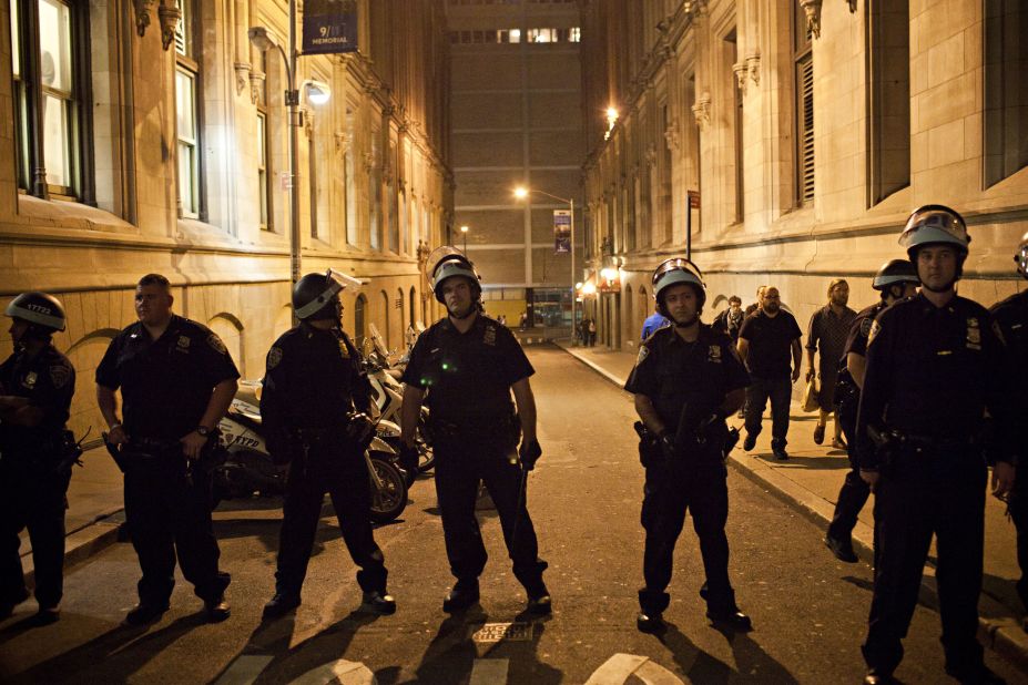 Police keep watch after monitoring an Occupy Wall Street march in New York City on Saturday.