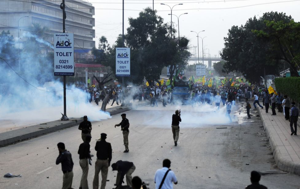 Pakistani police fire tear gas shells toward the protesters in Karachi on Sunday.