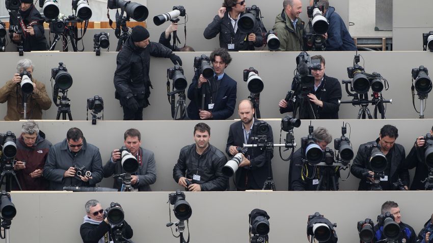 Press photographers wait on a temporary stand on the Queen Victoria Memorial in front of Buckingham Palace for Britain's Prince William and Kate, Duchess of Cambridge to appear on the balcony following their wedding on April 29, 2011.AFP PHOTO/WPA POOL/Oli Scarff (Photo credit should read OLI SCARFF/AFP/Getty Images)
