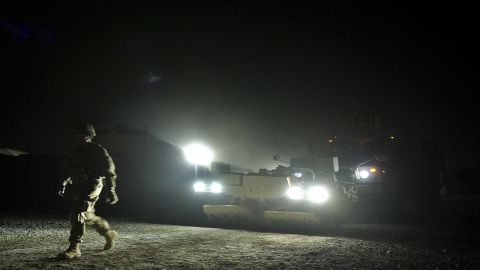 A U.S. army infantryman walks in front of a mine-resistant vehicle at Lindsey Forward Operating Base Saturday in Kandahar.