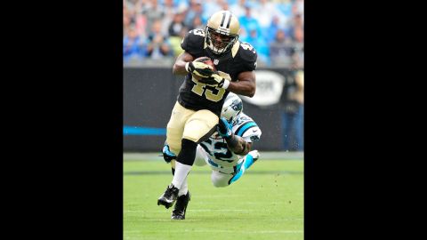 Jon Beason of the Carolina Panthers dives to bring down Darren Sproles of the New Orleans Saints on Sunday.