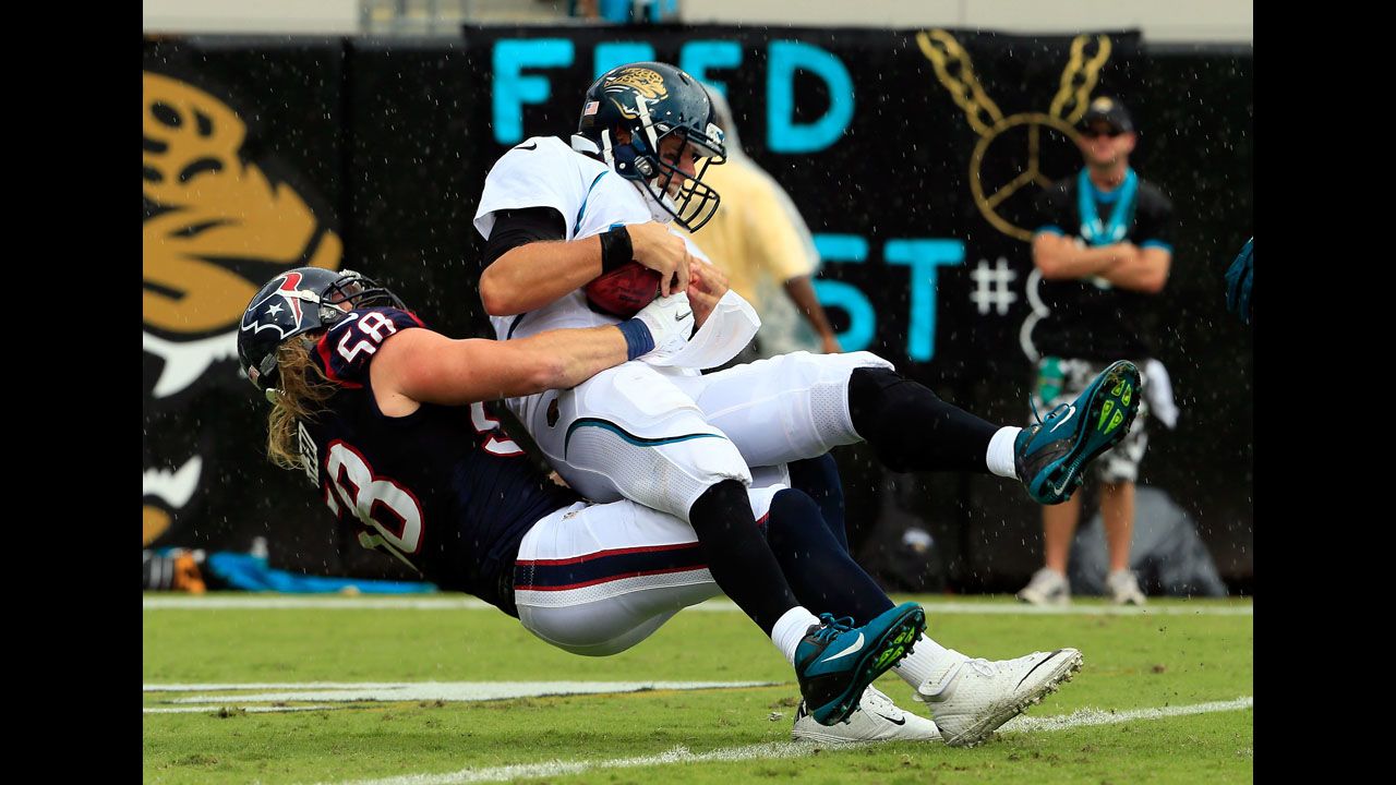 Blaine Gabbert of the Jacksonville Jaguars is sacked by Brooks Reed of the Houston Texans during Sunday's game.