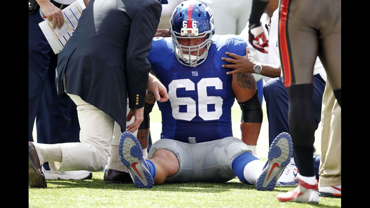 David Diehl of the New York Giants tries to get back to his feet after sustaining an injury against the Tampa Bay Buccaneers during Sunday's game at MetLife Stadium in East Rutherford, New Jersey.