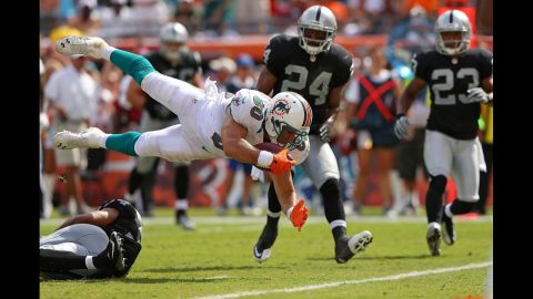 Tight end Anthony Fasano of the Miami Dolphins dives for a touchdown against the Oakland Raiders on Sunday at Sun Life Stadium in Miami Gardens, Florida.