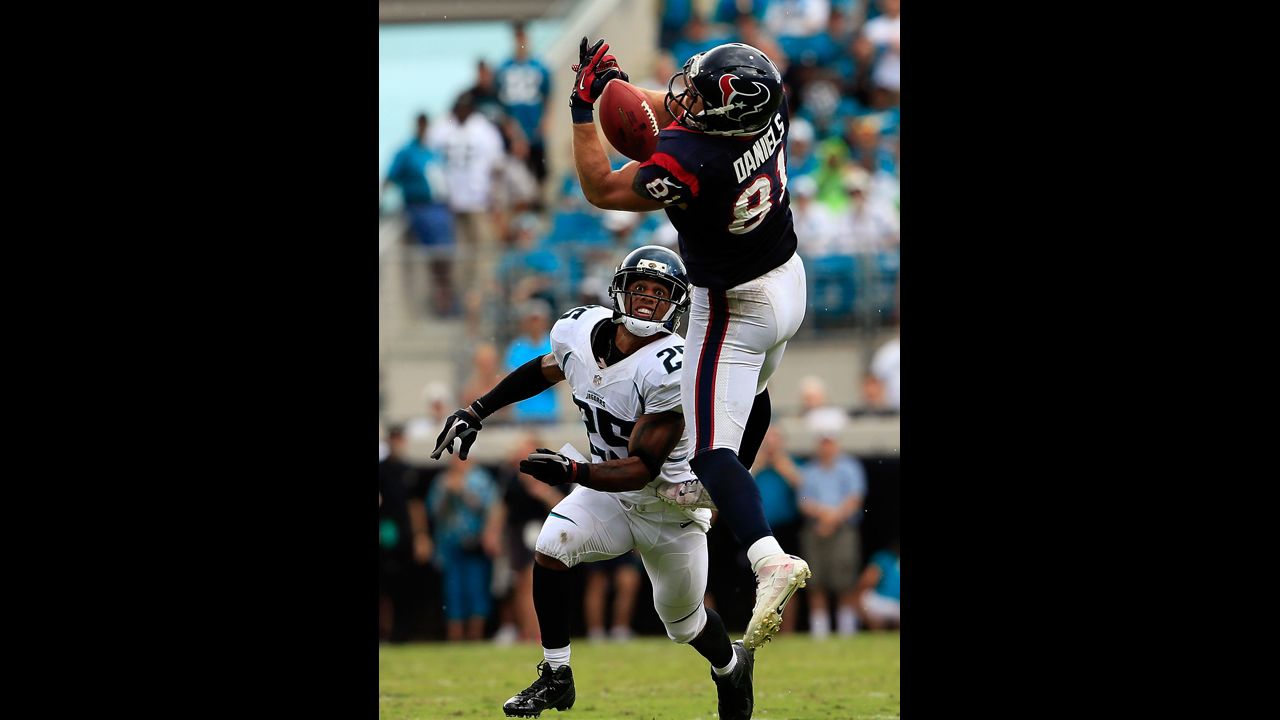 Owen Daniels of the Houston Texans attempts to catch a pass Sunday against Dwight Lowery of the Jacksonville Jaguars at EverBank Field in Jacksonville, Florida.