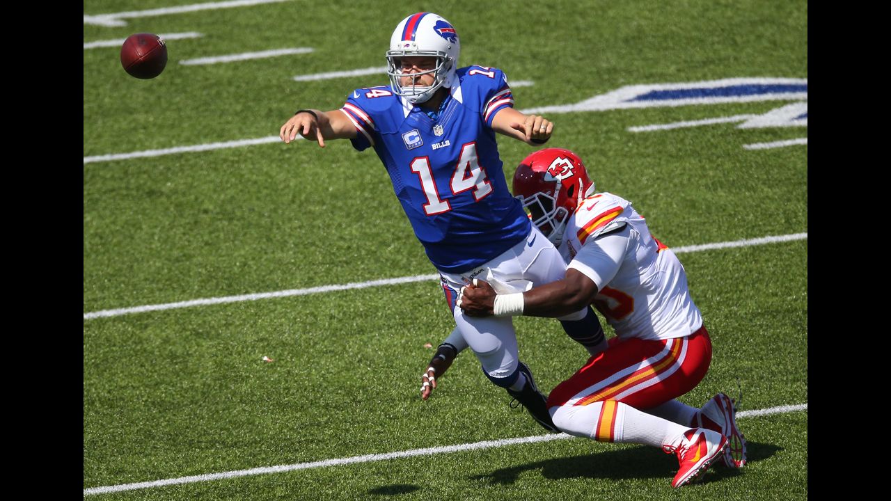 Quarterback Ryan Fitzpatrick of the Buffalo Bills throws the ball as he is tackled by Justin Houston of the Kansas City Chiefs on Sunday.