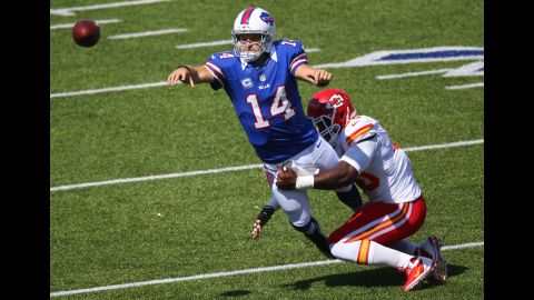 Quarterback Ryan Fitzpatrick of the Buffalo Bills throws the ball as he is tackled by Justin Houston of the Kansas City Chiefs on Sunday.