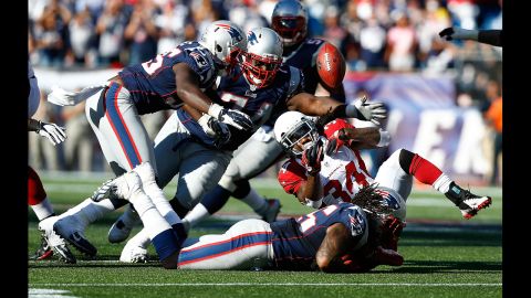 No. 55 Brandon Spikes of the New England Patriots forces a fumble by No. 34 Ryan Williams of the Arizona Cardinals in the fourth quarter Sunday.