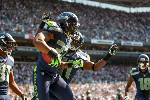 No. 32 Jeron Johnson of the Seattle Seahawks celebrates with No. 41 Byron Maxwell after recovering a blocked punt and returning it for a touchdown against the Dallas Cowboys on Sunday.