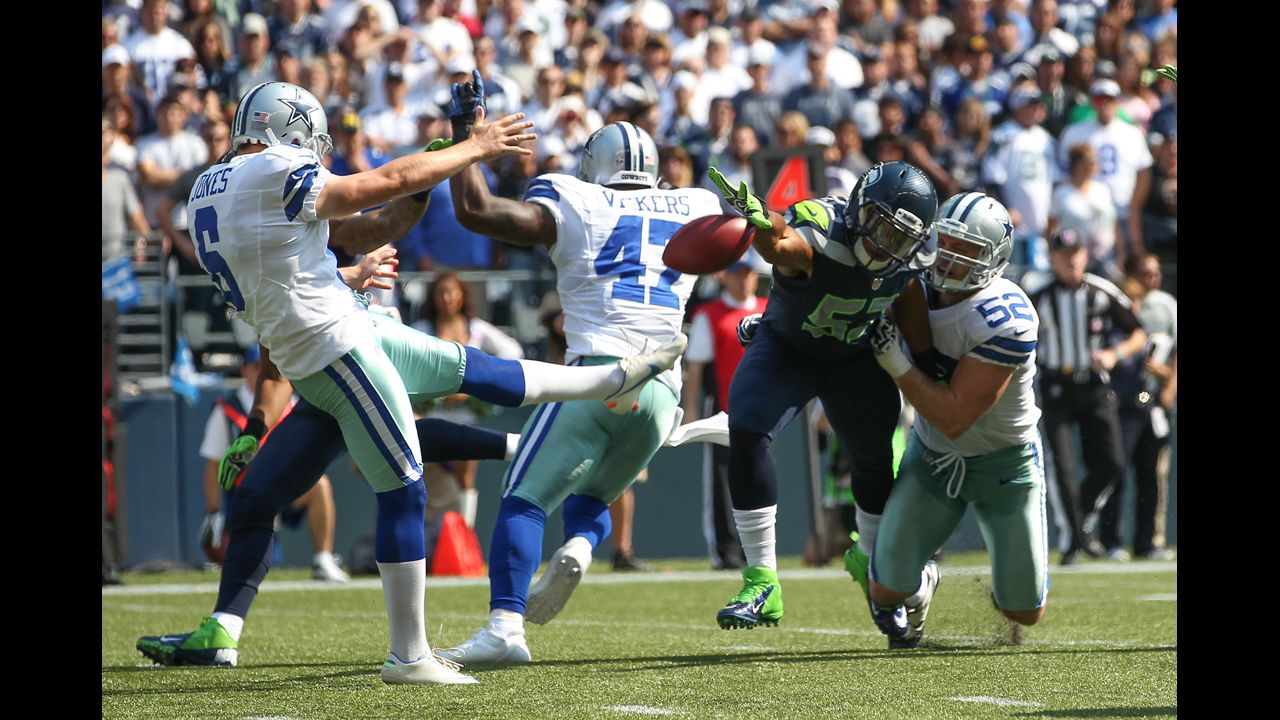 Linebacker Malcolm Smith of the Seattle Seahawks blocks a punt by Chris Jones of the Dallas Cowboys on Sunday.