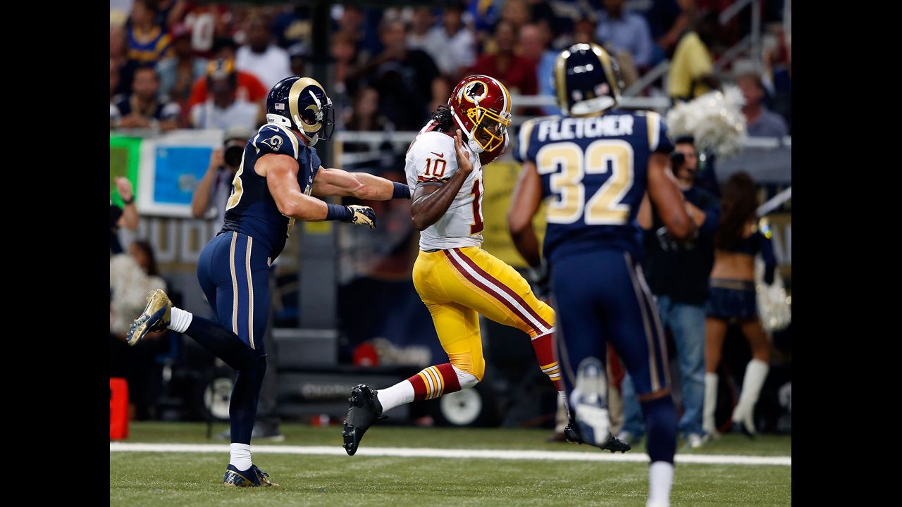 Quarterback Robert Griffin III of the Washington Redskins carries the ball over the goal line for a touchdown during Sunday's game against the St. Louis Rams.