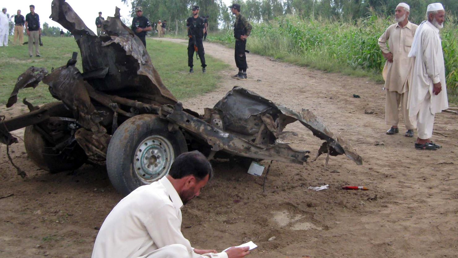 Pakistani security officials work at the site of a bomb blast in Jandol town, in the district of Lower Dir.