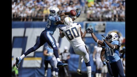 Robert Johnson of the Tennessee Titans, left, tips the ball past the hands of Malcom Floyd of the San Diego Chargers into the hands of Alterraun Verner, right, for an interception on Sunday.