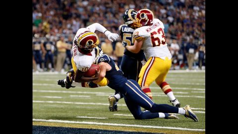 Quarterback Robert Griffin III of the Washington Redskins lunges over the goal line Sunday for a touchdown against the St. Louis Rams at Edward Jones Dome in St. Louis.