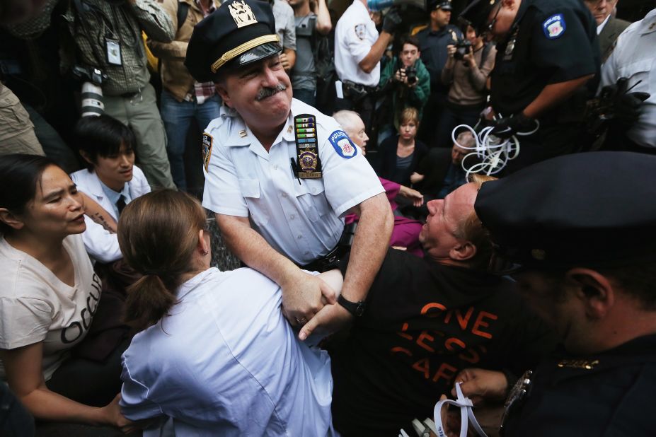 Protesters affiliated with Occupy Wall Street are arrested while attempting to form a "People's Wall" to block Wall Street on Monday.