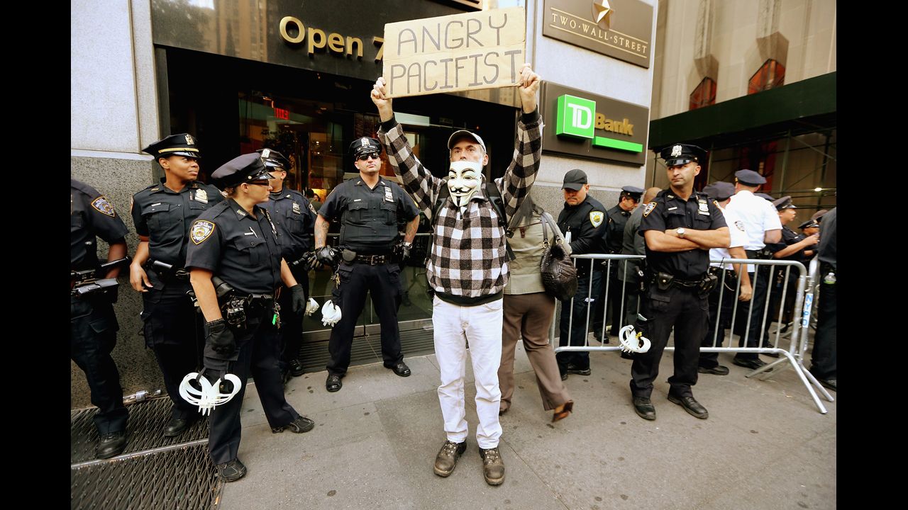 A protester affiliated with Occupy Wall Street stands near Wall Street on Monday.