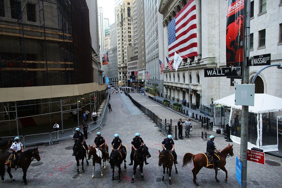 Police on horseback stand guard along Wall Street on Monday.