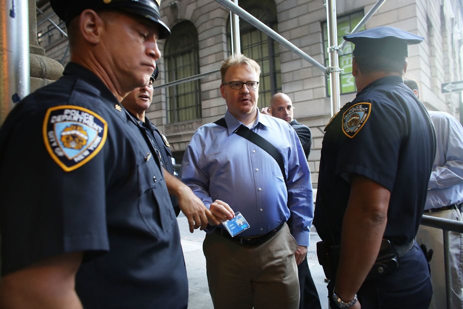People have their identification checked at a police blockade along Wall Street on Monday.