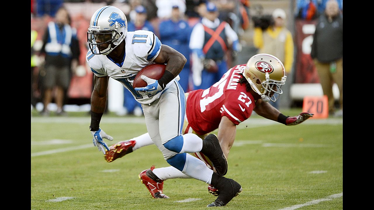Stefan Logan of the Detroit Lions gets tripped up by C.J. Spillman of the San Francisco 49ers during a punt return on Sunday.