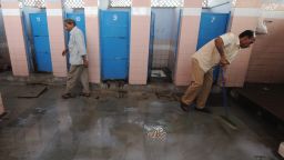 A cleaner mops up in a toilet complex run by Sulabh International at a railway station in New Delhi.