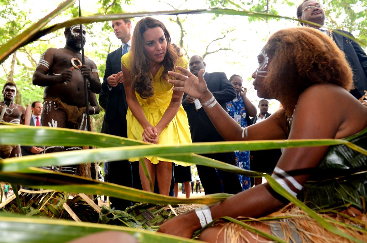 Catherine, Duchess of Cambridge, and Prince William speak with traditional weavers during a visit to a village in the Solomon Islands on Monday, September 17.
