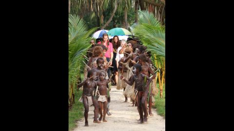 The Duke and Duchess of Cambridge are greeted by dancers as they visit Tuvanipupu Island in Honiara on Monday.
