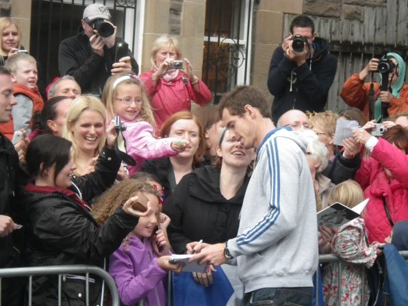 Murray, who beat Novak Djokovic in five sets to clinch his first grand slam title, spent four-and-a-half hours signing autographs and playing tennis with young fans at his former club.