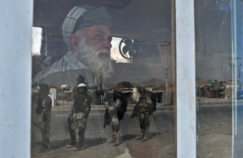 Afghan riot police are reflected through a window during an anti-U.S. protest Monday in Kabul, Afghanistan. Protesters attacked police along a road leading to the U.S. Embassy in Kabul.