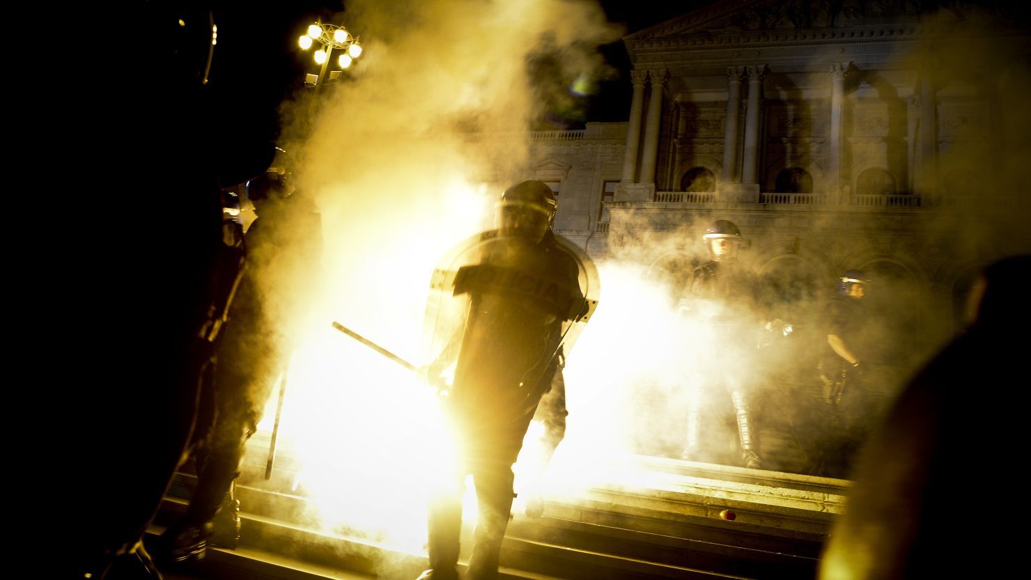 Riot police stands in front of the Portuguese Parliament during a protest in Lisbon on September 15.