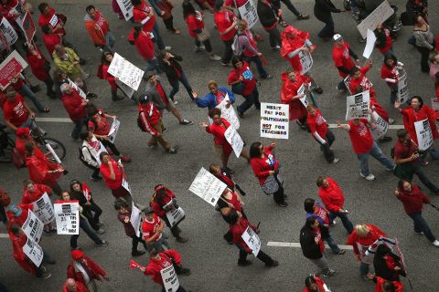 The protesters march down Michigan Avenue on Thursday. Vocal picketing has taken place in and around the city's schools.