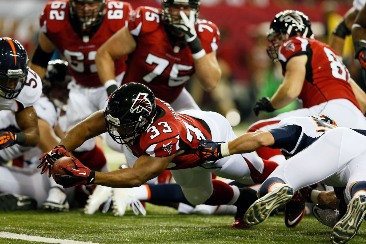 Running back Michael Turner of the Atlanta Falcons dives on a touchdown attempt in the first quarter against the Denver Broncos on Monday.