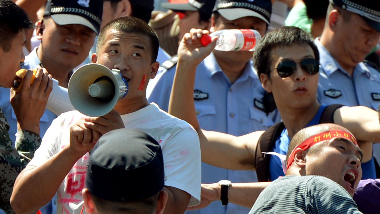Chinese protesters throw bottles in an anti-Japan rally outside the Japanese embassy on Tuesday in Beijing.
