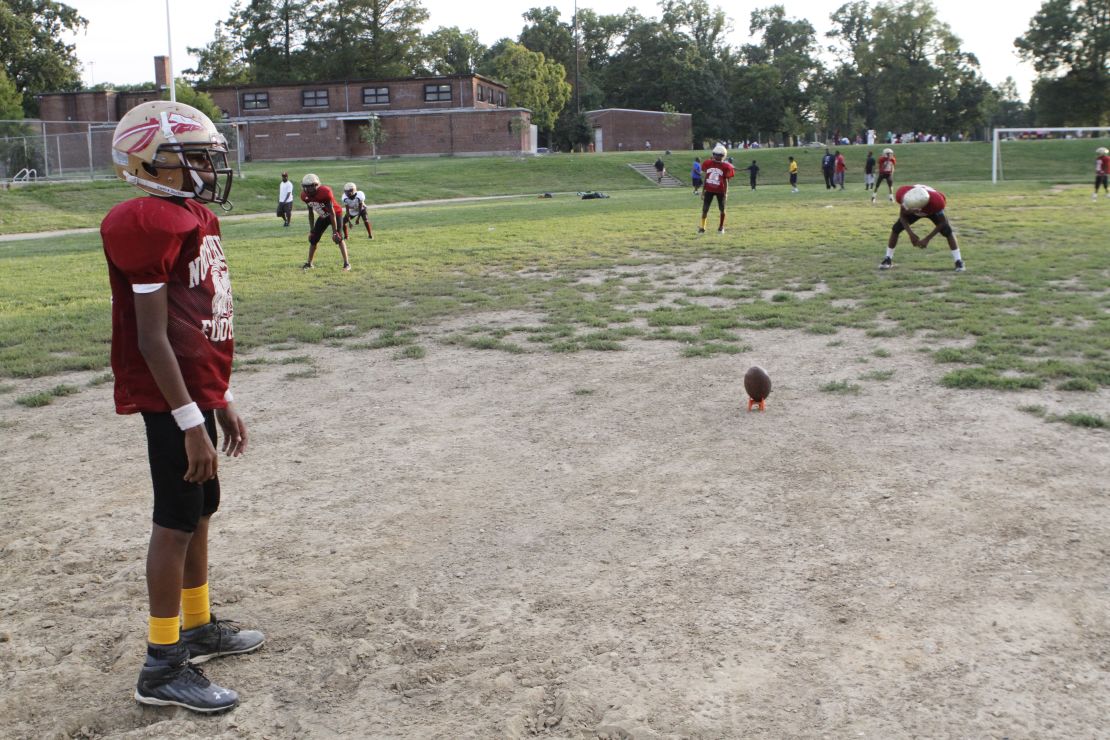 Nas Scott, 12, gets ready to kick off during practice. The Aztecs' dilapidated home field hasn't hosted a home game in 19 years.

