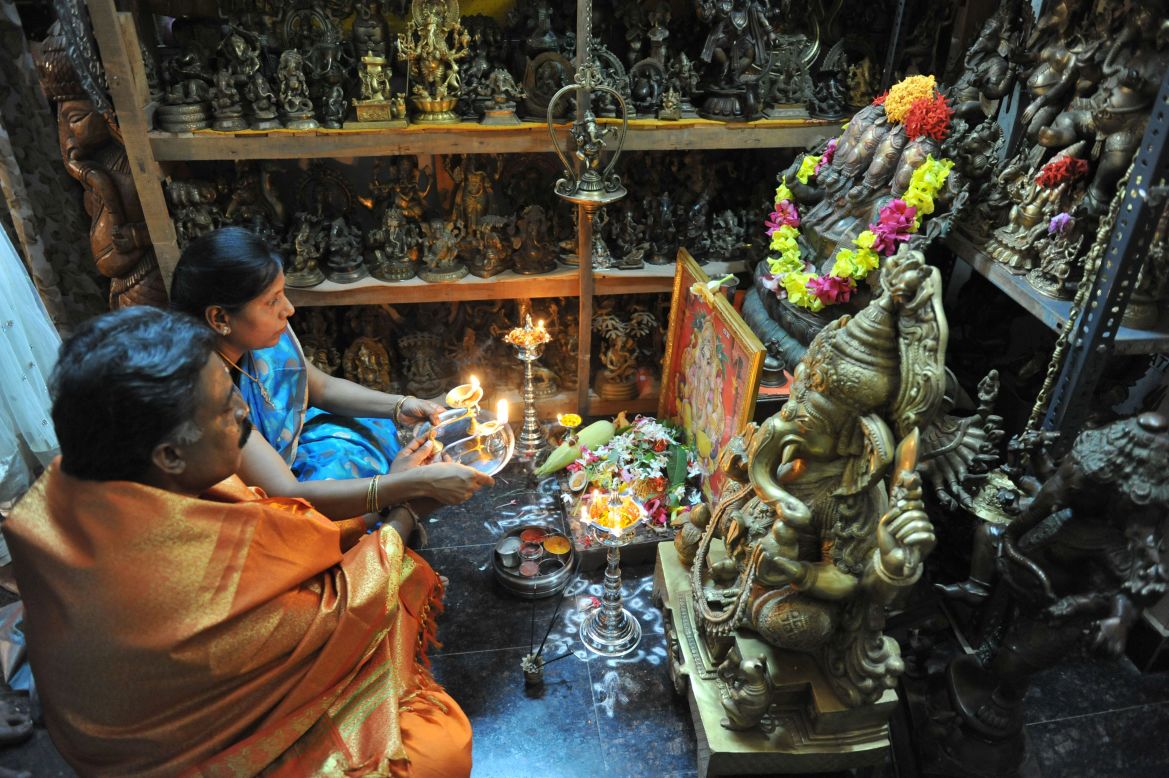 Collectors Pabsetti Shekhar and his wife Pabsetti Anuradha perform ritual prayers to idols of Ganesh, the elephant-headed Hindu lord, at their home in Hyderabad on Tuesday, September 18, the day before the  Ganesh Chaturthi Festival. Shekhar, 50, has a collection of 12,022 Ganesh idols. Hindu devotees bring home idols of Lord Ganesha in order to invoke his blessings for wisdom and prosperity ahead of the 11-day Ganesha Festival beginning Wednesday.