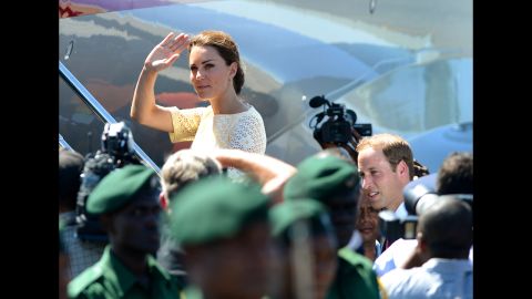 Catherine, Duchess of Cambridge, waves goodbye to onlookers as she and Prince William board a plane to leave the Solomon Islands from Honiara on Tuesday, September 18.