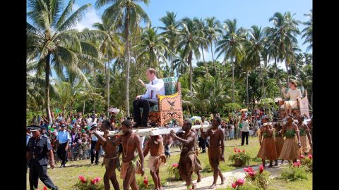 Prince William and Catherine, Duchess of Cambridge, are carried from a boat to their plane Tuesday in Honiara, Guadalcanal Island in the Solomon Islands as they continue their tour of the Far East.