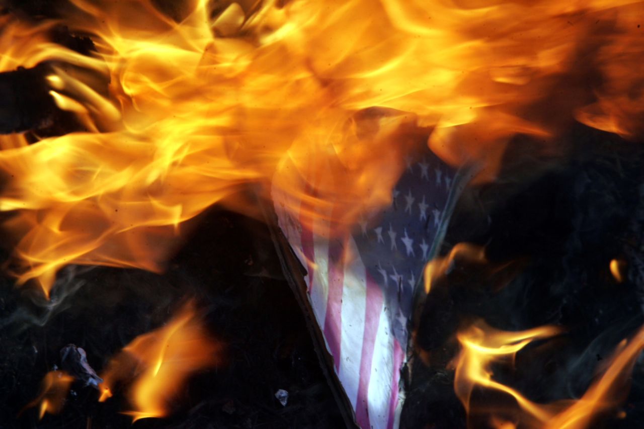 Indian Muslims burn an American flag with a picture of U.S. President Barack Obama as they protest against a U.S.-made anti-Islam film on Tuesday, September 18, near the U.S. Consulate in Chennai. About 5,000 people have gathered in front of the building. Google India has already blocked access to the film, which the government has condemned as "offensive."