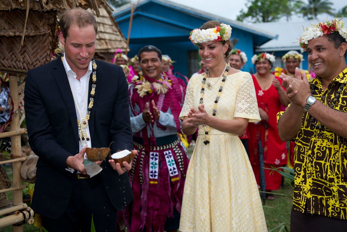 Prince William opens a coconut with a machete as Catherine, Duchess of Cambridge, watches on Tuesday in Tulavu.