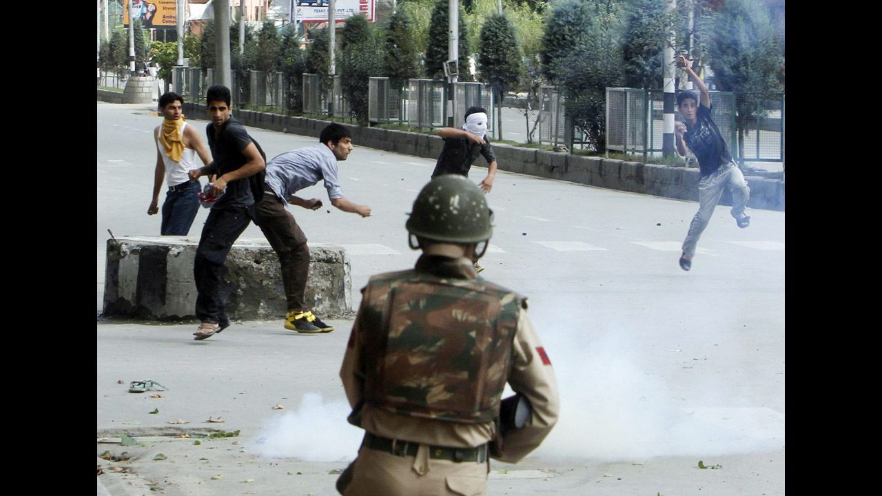 Kashmiri Muslims throw stones at Indian police during a protest on Tuesday in Srinagar.