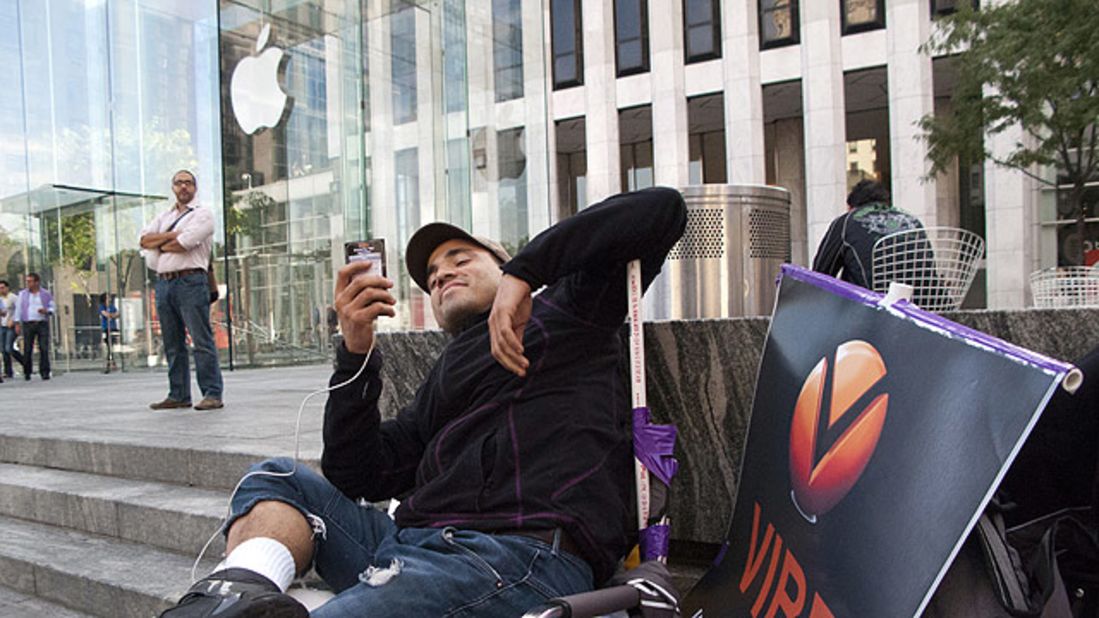 A man waits in line Monday outside the flagship Apple store on 5th Avenue in New York.