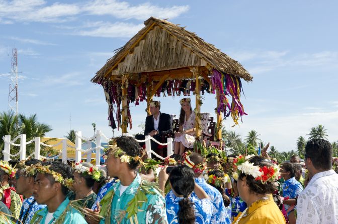 Prince William and Catherine, Duchess of Cambridge, are carried as they bid farewell in Tuvalu on Wednesday, September 19. The Duke and Duchess of Cambridge -- on a tour marking the diamond jubilee of Queen Elizabeth II -- are visiting Singapore, Malaysia, the Solomon Islands and Tuvalu. <a href="index.php?page=&url=http%3A%2F%2Fwww.cnn.com%2FSPECIALS%2Fworld%2Fphotography%2Findex.html" target="_blank">See more of CNN's best photography</a>.