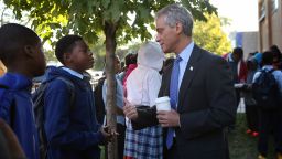 Mayor Rahm Emanuel greets students as they arrive at Frazier International Magnet School on Wednesday, September 19, in Chicago. Wednesday was the first day back for students and teachers after union representatives voted to suspend the eight-day strike.