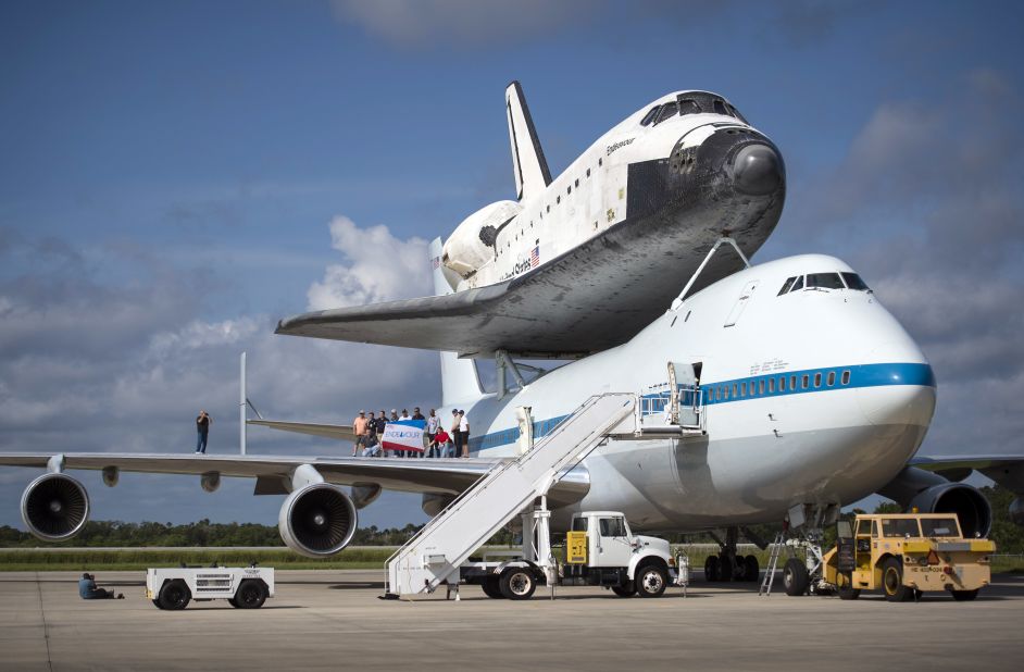 Workers pose for a photograph on the wing of NASA's Shuttle Carrier Aircraft Wednesday, with the space shuttle Endeavour perched on top.