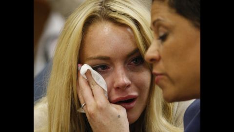 Lohan cries next to her lawyer Shawn Chapman Holley as she is sentenced to 90 days in jail by Judge Marsha Revel during her hearing at the Beverly Hills Courthouse in July 2010. Lohan violated her probation in two 2007 drunk driving cases. 