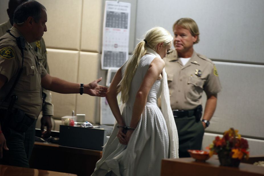 Lohan is led away in handcuffs at her probation progress report hearing in Los Angeles in October 2011. 