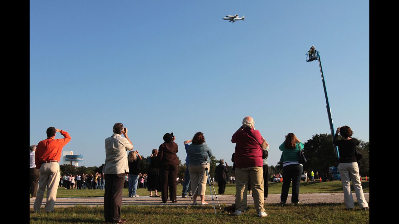 Spectators watch as Endeavour is carried over Stennis Space Center in Hancock County, Mississippi, on Wednesday.