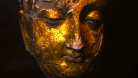 A gold-plated Buddha head found at Mes Aynak. A team of international archaeologists is scrambling to save relics.