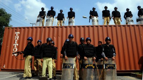Pakistani police stand guard on a blocked street in front of the U.S. Consulate during a protest in Lahore on Wednesday.